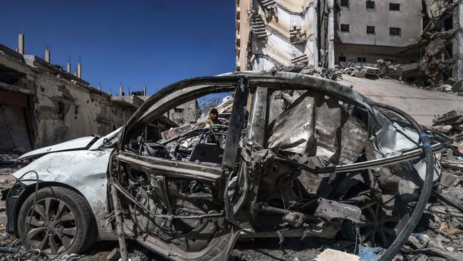 The remains of a car and destroyed buildings in Rafah. Picture: AFP