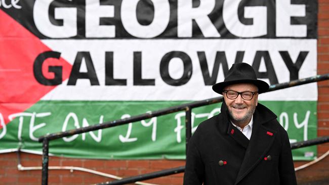 The new Workers Party Member of parliament for Rochdale, George Galloway poses for a photograph outside his campaign headquarters in northern England.