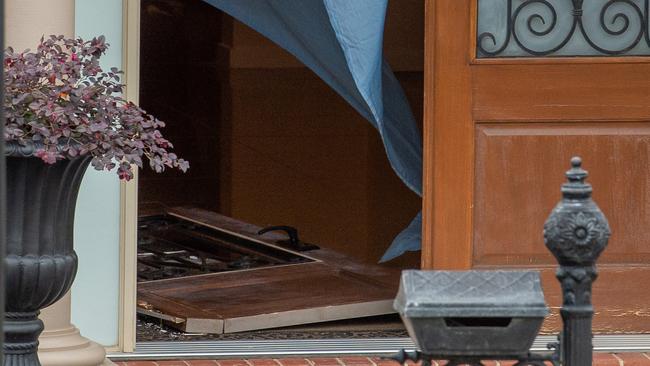 A door bashed down at a house in Mernda. Picture: Jay Town