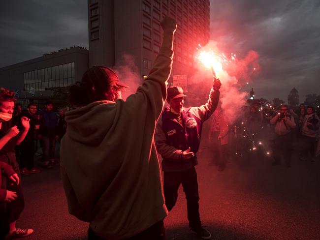 Anti-G7 protesters throw flares while demonstrating ahead of the summit in Quebec City. Picture: Darren Calabrese/The Canadian Press via AP