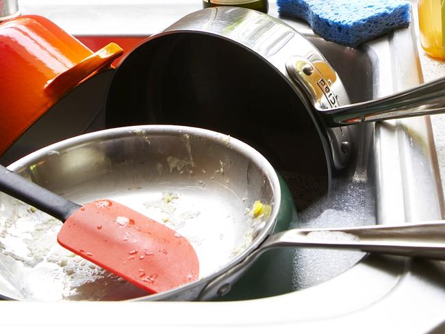 Generic image of dirty dishes piled in a kitchen sink. From Thinkstock.