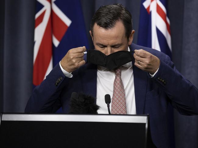 PERTH, AUSTRALIA - JANUARY 31: Premier Mark McGowan is seen placing his mask on at Dumas House Press Room on January 31, 2021 in Perth, Australia. Premier Mark McGowan has announced a five day lockdown across the Perth, Peel and South West regions of Western Australia, effective from 6pm local time on Sunday 21 January. The lockdown measures come following the discovery of a positive COVID-19 case in a worker at a quarantine hotel. (Photo by Matt Jelonek/Getty Images)