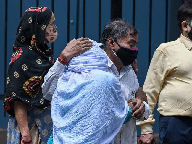 Relatives mourn as they wait to receive the body of their loved one, who died due to coronavirus, at a mortuary in New Delhi. Picture: AFP