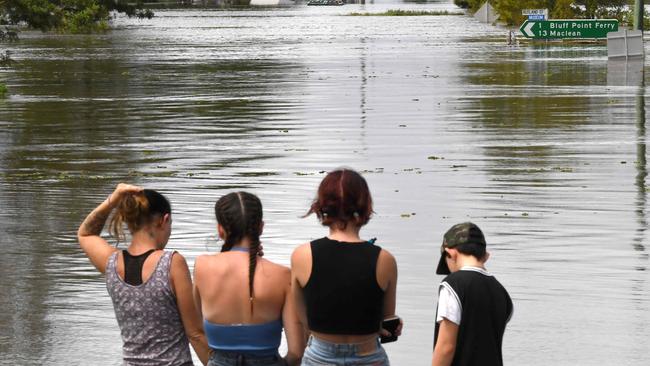 Residents stand by a flooded street on March 1, 2022. Photo: Saeed Khan.