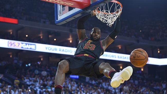 Cleveland Cavaliers star LeBron James slam dunks against the Golden State Warriors on Christmas Day.