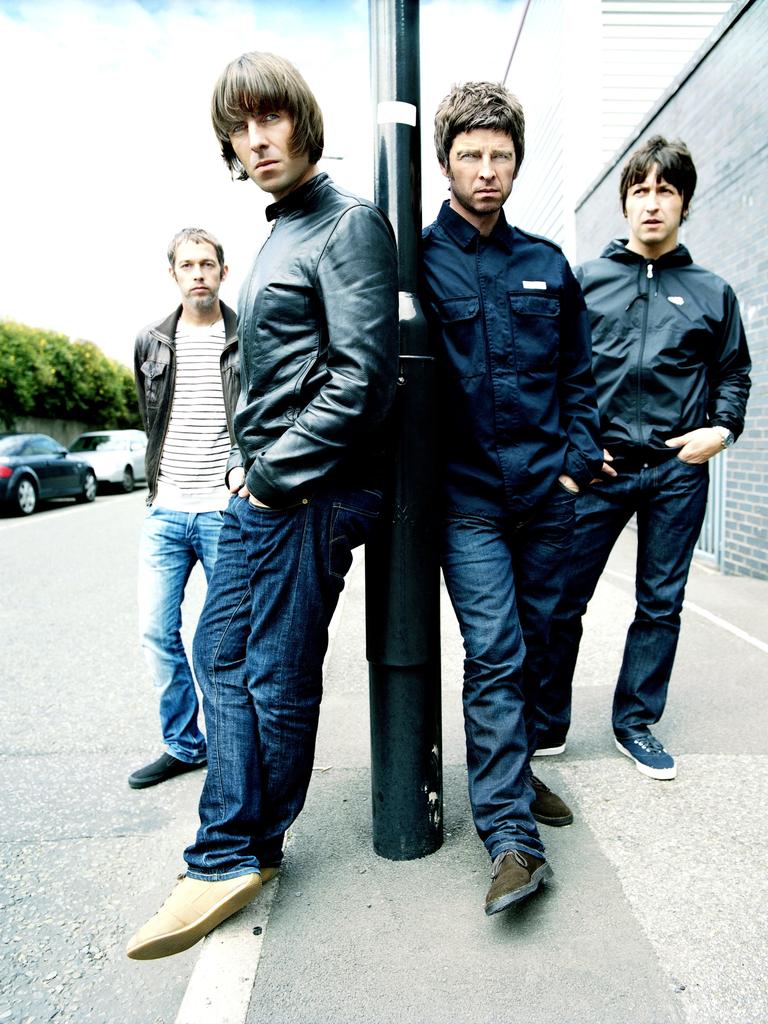 Liam (left) with brother Noel (right) with their band Oasis.