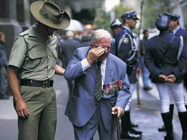 A Portrait of Australia: The best stories from 30 years of Australian Geographic. On a day charged with emotion, a young digger comforts WWII veteran Ossie Ostara, who missed his starting point for Sydney’s Anzac Day march. Photo by David Mariuz.
