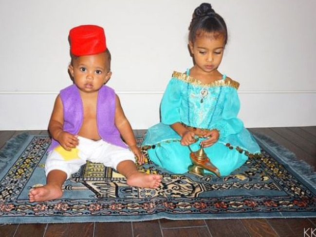 Saint and North West pose in Aladdin-inspired costumes while sitting on their own magic carpet taken from <a href="https://www.kimkardashianwest.com/">kimkardashianwest.com.</a>