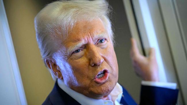 US President Donald Trump speaks with the press on board Air Force One after departing Las Vegas, Nevada, en route to Miami, Florida on January 25, 2025. After visits to disaster sites in North Carolina and California, the Vegas stop is more of a feel-good victory lap, as he lays out his plans to exclude tips from federal taxes -- an enormously popular move in a city built on the hospitality industry. (Photo by Mandel NGAN / AFP)