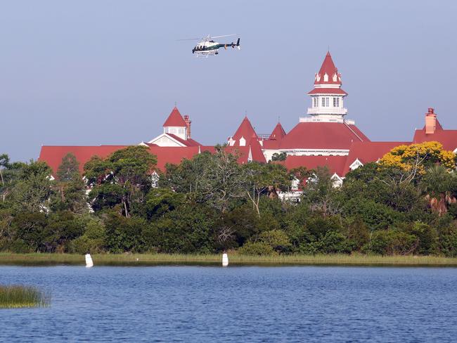 A helicopter searches for the young boy who was dragged into the water Tuesday night by an alligator near Disney's Grand Floridian Resort &amp; Spa in Lake Buena Vista, Florida. Picture: Red Huber/Orlando Sentinel