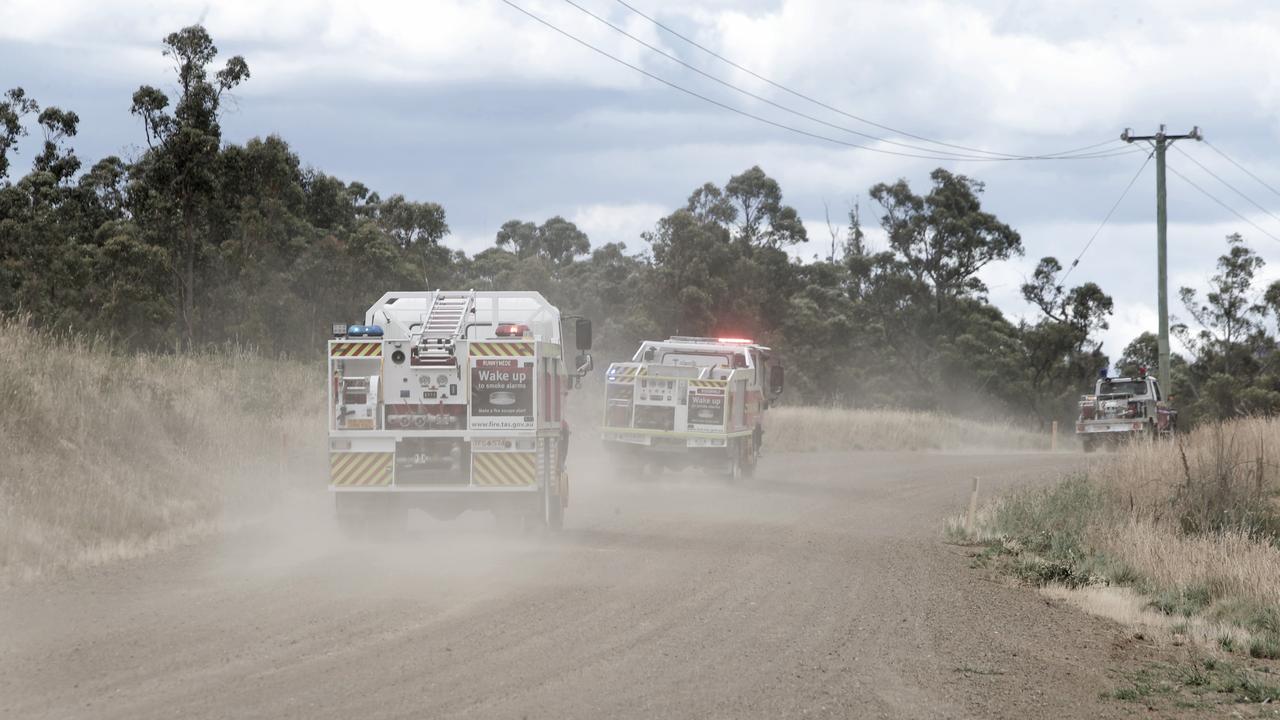 Fire trucks race towards Huonville and Jubury yesterday as the area's alert level is lifted to emergency warning level. Picture: PATRICK GEE