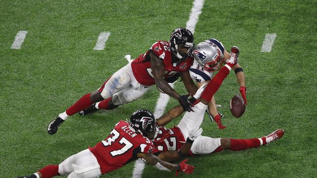 HJulian Edelman #11 of the New England Patriots makes a 23 yard catch in the fourth quarter against Ricardo Allen #37, Robert Alford #23 and Keanu Neal #22 of the Atlanta Falcons