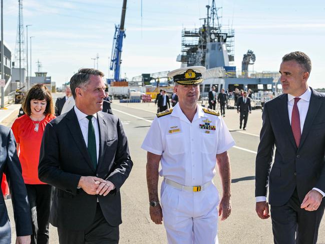 ADELAIDE, AUSTRALIA - NewsWire Photos MARCH 15, 2023: Acting Prime Minister Richard Marles, left, Vice Admiral Jonathan Mead, Chief of the Nuclear Powered Submarine Task Force and South Australian Premier Peter Malinauskas discuss the build of the AUSKUS submarines at the Osborne Naval Shipyard. Picture: NCA NewsWire / Brenton Edwards