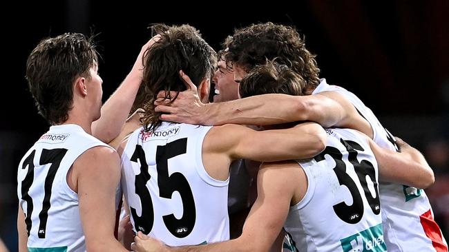 Daniel McKenzie is congratulated by teammates after kicking a goal. Picture: Getty Images