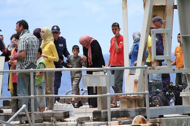 Frightened children were comforted by their parents during the operation to bring them ashore. Picture: Kent Retallick