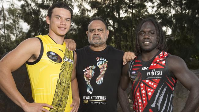 Richmond’s Daniel Rioli and Essendon’s Anthony McDonald-Tipungwuti with Michael Long. Picture: Michael Klein