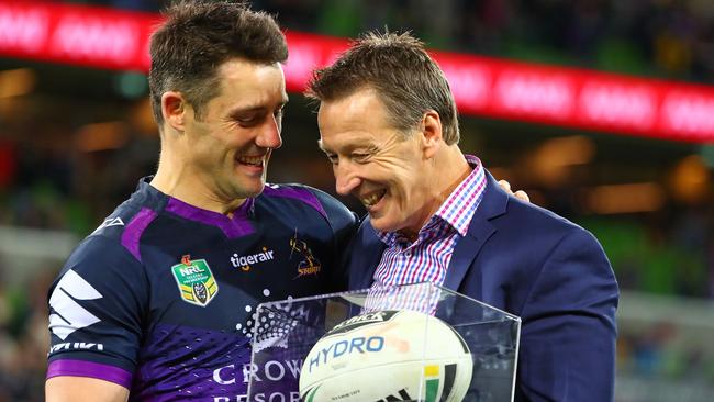 Storm coach Craig Bellamy presents Cooper Cronk with the match ball after Cronk played his final home match.