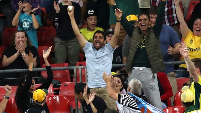 A fan catches a ball in the crowd at the MCG last summer. Picture: Phil Hillyard