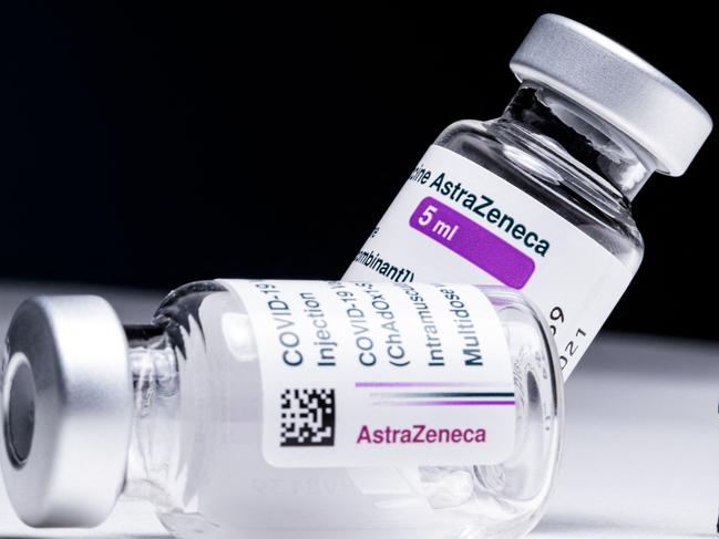 (FILES) This file illustration picture shows vials of the AstraZeneca Covid-19 vaccine and a figurine taken in a studio Paris on March 11, 2021. - A growing list of countries have suspended AstraZeneca's Covid-19 shots amid fears over blood clots and other possible side effects, despite the company and the World Health Organization insisting there is no risk. (Photo by JOEL SAGET / AFP)