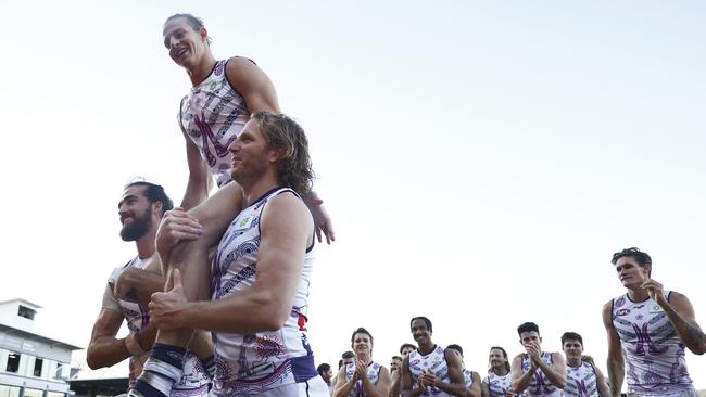 LAUNCESTON, AUSTRALIA - JULY 10: Nat Fyfe of the Dockers is chaired off by Alex Pearce of the Dockers (L) and David Mundy of the Dockers after winning the round 17 AFL match between Hawthorn Hawks and Fremantle Dockers at University of Tasmania Stadium on July 10, 2021 in Launceston, Australia. (Photo by Daniel Pockett/AFL Photos/via Getty Images)