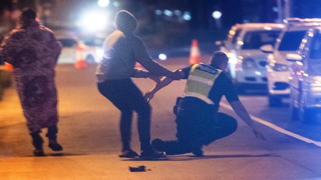 Crowds broke through the police line at the scene. Picture: Tony Gough