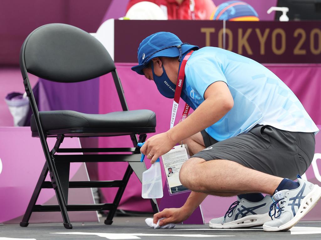 A volunteer clears an athlete area during the swimming.