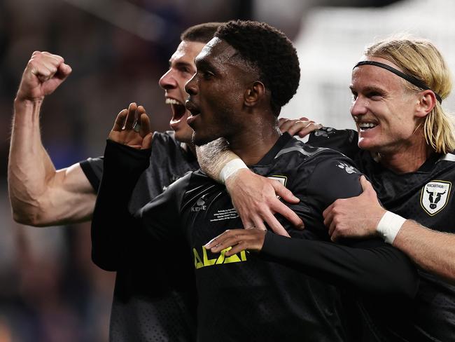 SYDNEY, AUSTRALIA - OCTOBER 01: Al Hassan Toure of Macarthur FC celebrates scoring a penalty with team mates during the Australia Cup Final match between Sydney United 58 FC and Macarthur FC at Allianz Stadium on October 01, 2022 in Sydney, Australia. (Photo by Cameron Spencer/Getty Images)