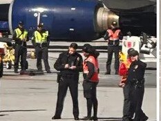 Law enforcement detained the unidentified passenger who allegedly opened an emergency exit door aboard the plane. (Gillian Sheldon via Twitter)