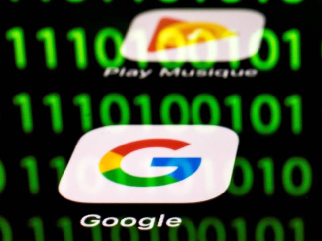 (FILES) In this file photo taken on April 20, 2018 shows an illustration picture in Paris shows apps for Google, Amazon, Facebook, Apple (GAFA) and the reflexion of a binary code displayed on a tablet screen. - The OECD published on October 9, 2019, its suggestions for a "unified approach" on fairly taxing digital giants to break a deadlock in a dispute that has raised tensions between the United States and some EU allies. (Photo by Lionel BONAVENTURE / AFP)