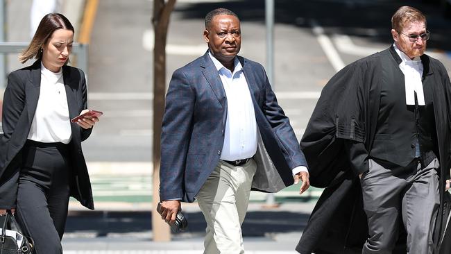 Hervey Bay doctor Olajide Ogunseye outside Brisbane District Court with his legal team. Photographer: Liam Kidston.