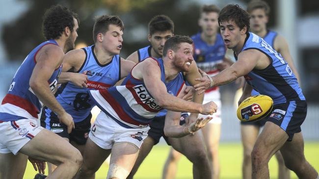 Sturt players heap the pressure on Central's Jarrod Schiller as he gets a handball away. Picture: AAP Image/Dean Martin