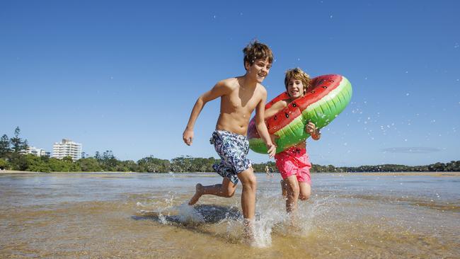 Twins Rodrigo and Jorge Valz, 11, from Alicante in Spain, lap up the return of warm weather at Currimundi on the Sunshine Coast. Picture: Lachie Millard