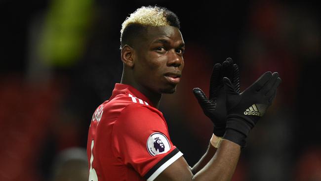 Manchester United's French midfielder Paul Pogba applauds the fans at the end of the English Premier League football match between Manchester United and Stoke City at Old Trafford in Manchester, north west England, on January 15, 2018. / AFP PHOTO / Oli SCARFF / RESTRICTED TO EDITORIAL USE. No use with unauthorized audio, video, data, fixture lists, club/league logos or 'live' services. Online in-match use limited to 75 images, no video emulation. No use in betting, games or single club/league/player publications.  /