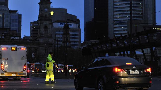 A police officer directs traffic around the CBD amidst the September, 28, 2016 blackout, which affected the entire state. Photo: AAP Image/David Mariuz