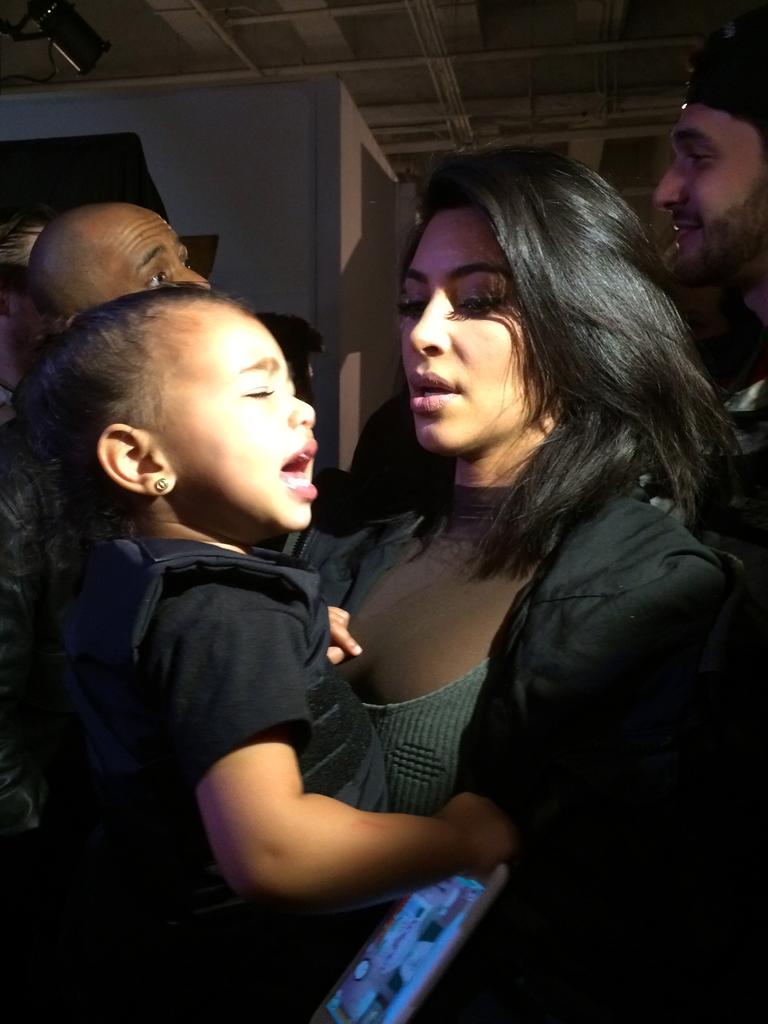 Kim Kardashian holds her daughter North West after the Adidas Originals x Kanye West YEEZY SEASON 1 fashion show during New York Fashion Week. Picture: Getty