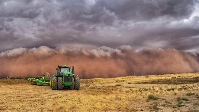 The Kerang duststorm dwarfs a tractor. Picture: Drew Chislett