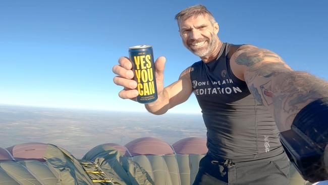 Damien Rider on top of the hot-air balloon he scaled before parachuting off the top. Picture: Supplied.