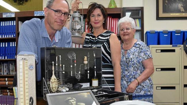 THE PAST IS PRESENT: Frank Le Bacq, Nicole White and Mary Potter with some of Gympie Hospital's history and (below) the hospital as it once was. Picture: Scott Kovacevic