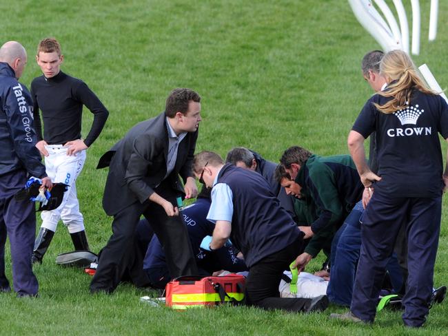 Medical and track staff attend to jockey Danny Brereton.