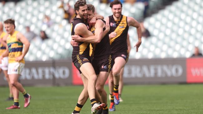 Max Proud (left) embraces Chris Curran after Curran goaled during Glenelg’s elimination final win against Woodville-West Torrens. Picture: Cory Sutton/SANFL