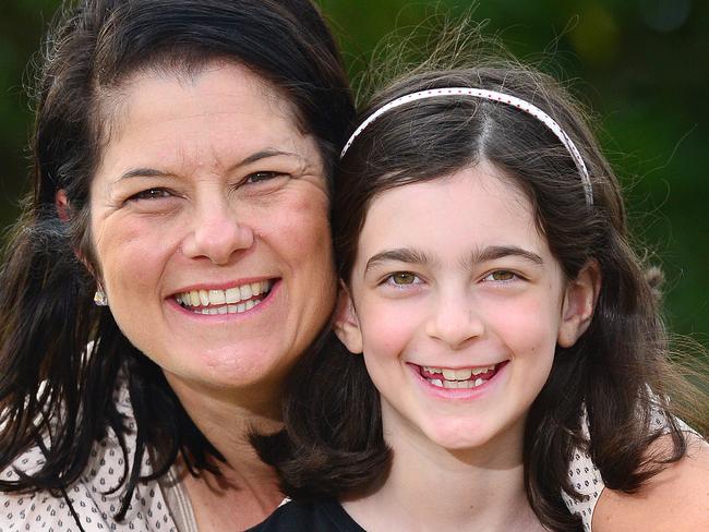 Pannee Agathos with daugher Alex, 8, who are happy that Catholic Education Melbourne will be offering catholic school families fee relief due to the coronavirus.Picture : Nicki Connolly