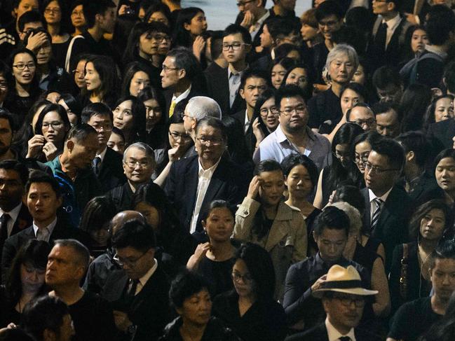 Lawyers and law students take part in a silent march in protest at a ruling by China which effectively bars two pro-independence legislators from taking office in Hong Kong on November 8, 2016. Hundreds of lawyers and law students, all dressed in black, marched silently through Hong Kong on November 8 in protest at a ruling by China which effectively bars two pro-independence legislators from taking office. / AFP PHOTO / Anthony WALLACE