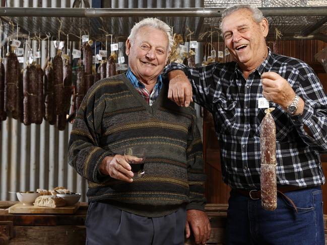 Dominic Fattore (left) with his brother Ferruccio Fattore with their salami which is maturing, ahead of the Italian Festival in Griffith. The festival started in 1972 as their family tried to settle once and for all with another Italian family over who made the best salami. Picture: Jonathan Ng