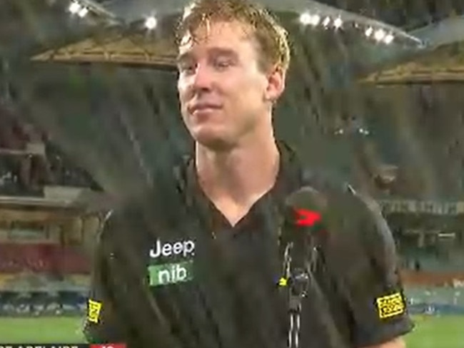 Tom Lynch is soaked by a drink thrown by a fan.