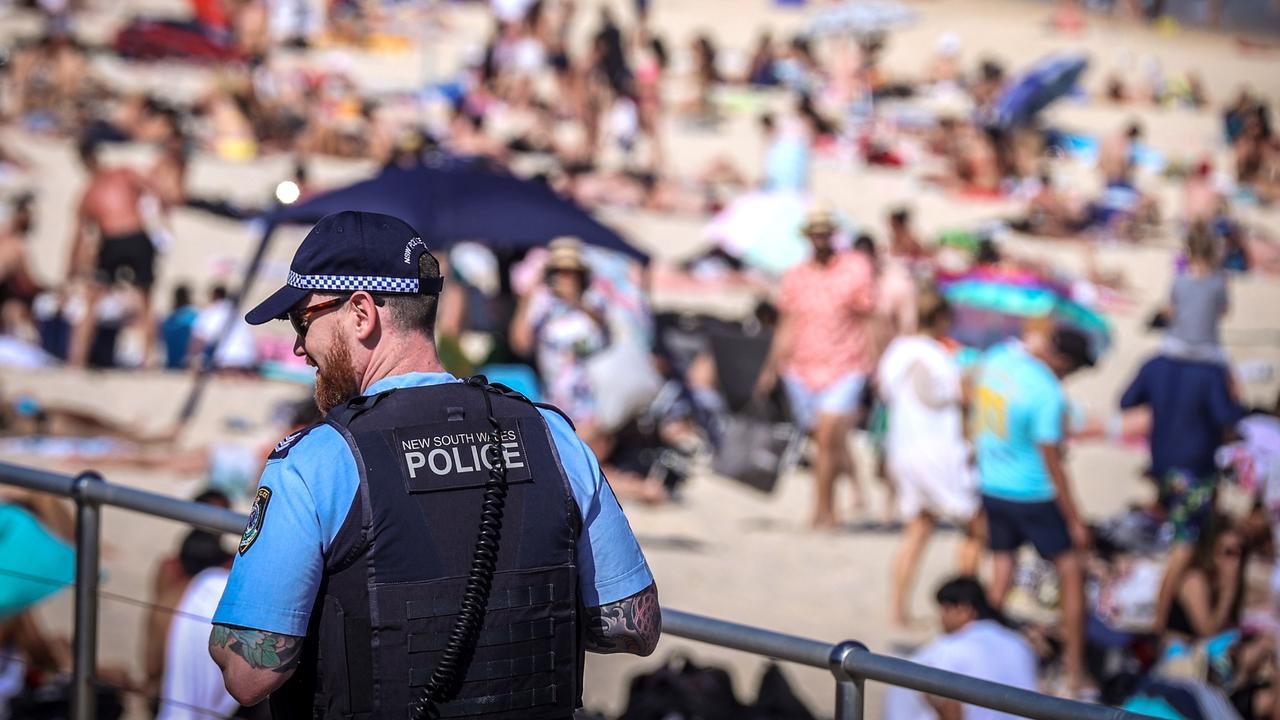 A policeman patrols as people visit Bondi Beach in Sydney on Monday. Picture: David Gray/AFP