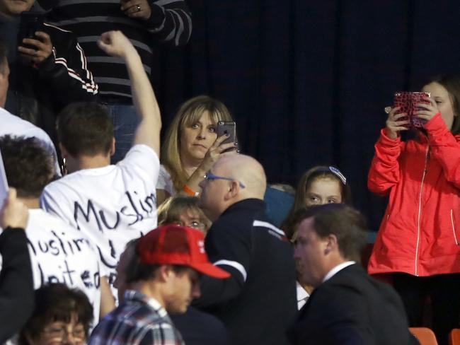 Attendees watch as protesters are removed before the Chicago rally was cancelled.