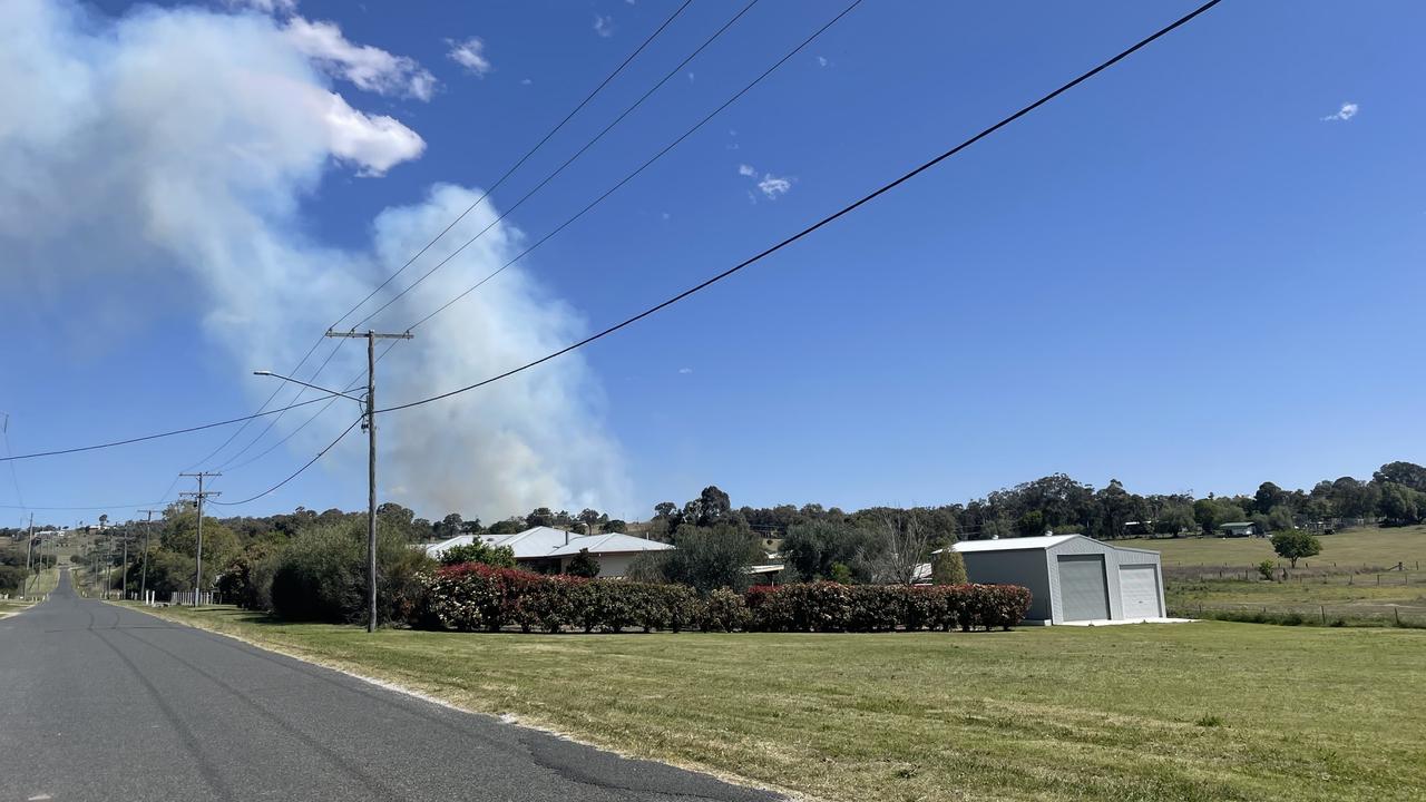 Plumes of smoke from a fast moving grass fire on Ford Rd can be seen from Warner St. Photo: Michael Hudson