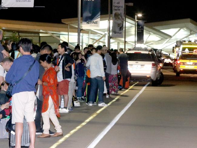 Stranded passengers and loved ones on the ramp at Brisbane Airport’s international terminal. Picture: Steve Pohlner/AAP