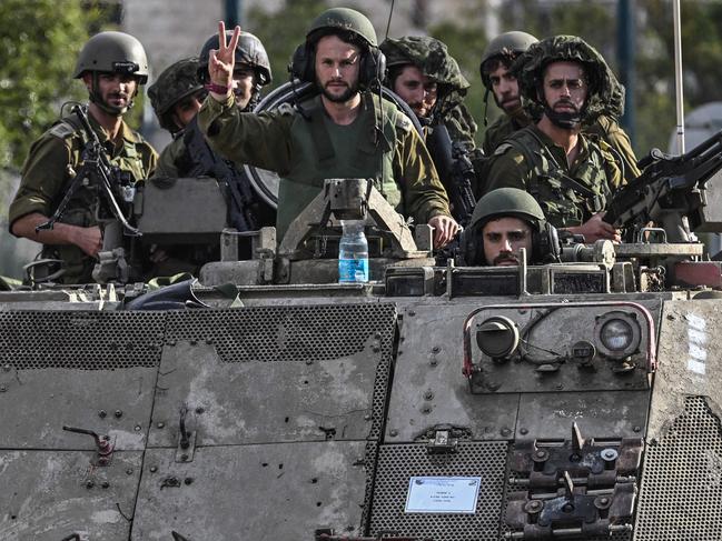 Israeli soldiers patrol in armoured personnel carriers at an undisclosed position in northern Israel near the borer with Lebanon. Picture: AFP