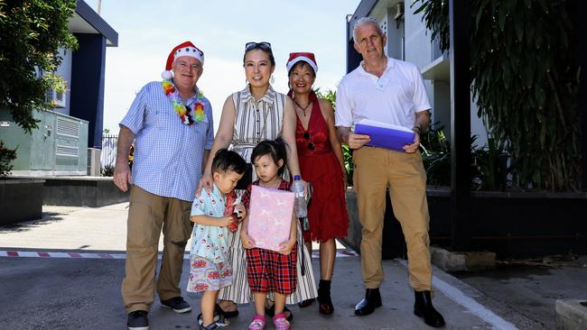 The Cairns Community Christmas Lunch has served over 400 traditional Christmas meals to those in need at St Augustine's College. Cairns Community Christmas Lunch organiser David Lennie hands out girls to Serena Choi and her children Vanha Kwak, 2, and Xelha Kwak, 4, supported by Lunch volunteers Olivia McLeod and Peter Shervey. Picture: Brendan Radke